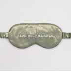 Olive green silk sleep mask with "FIVE MORE MINUTES" embroidery